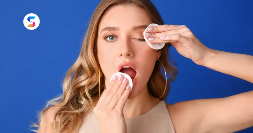 a girl removing her makeup with makeup wipes