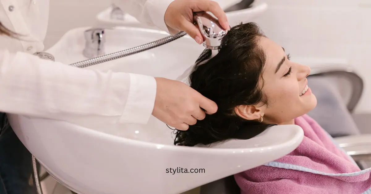 a girl at a parlor washing her hair with water only