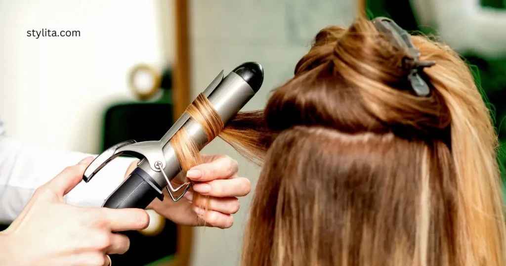 A brown hair girl curling her hair with curling iron