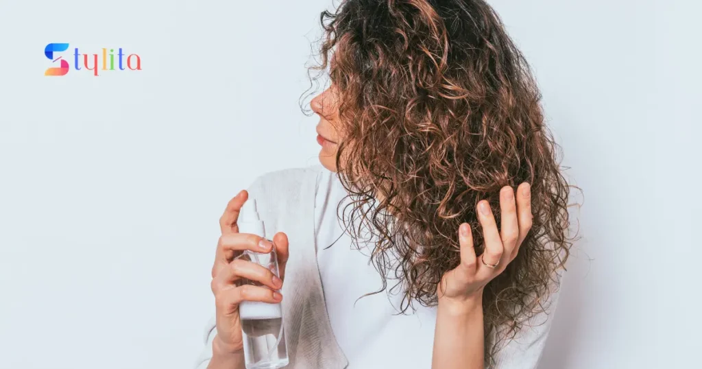 a girl moisturizing her hair with moisturizing spray on her perm hair