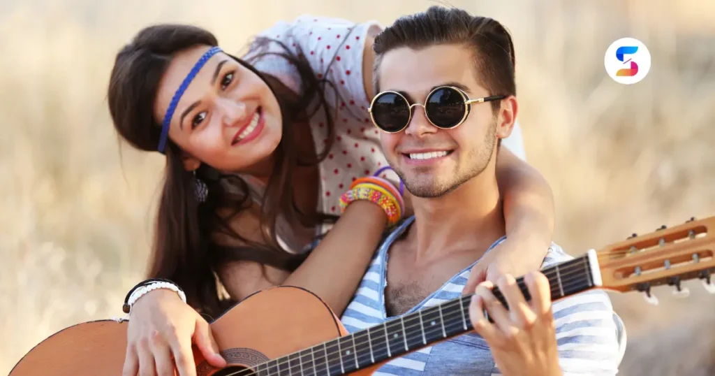 a beautiful couple in bohemian style with a guitar