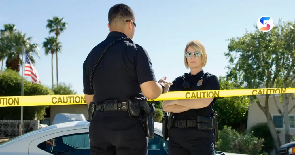 a police girl standing with her male colleague at a crime scene