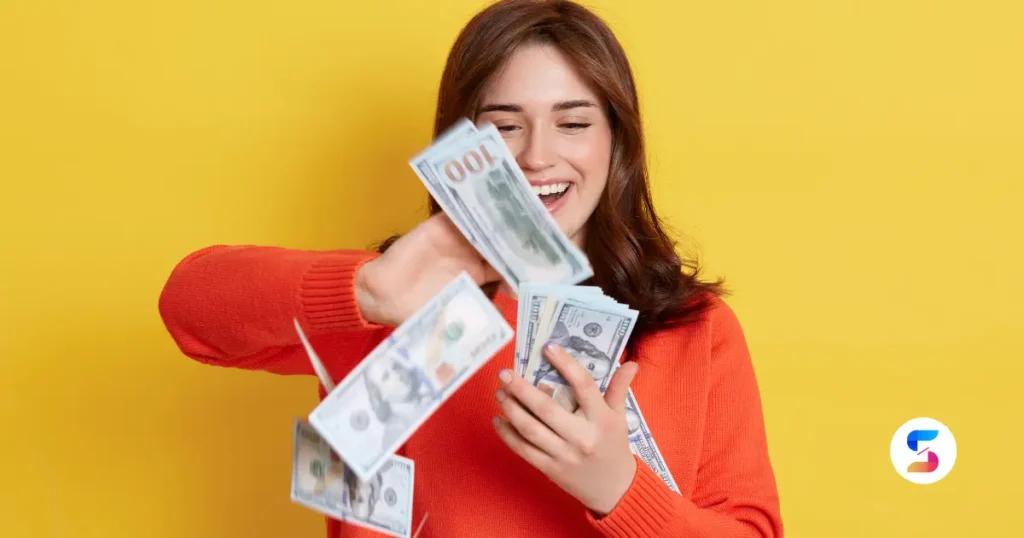 a rich girl playing with dollar currency notes